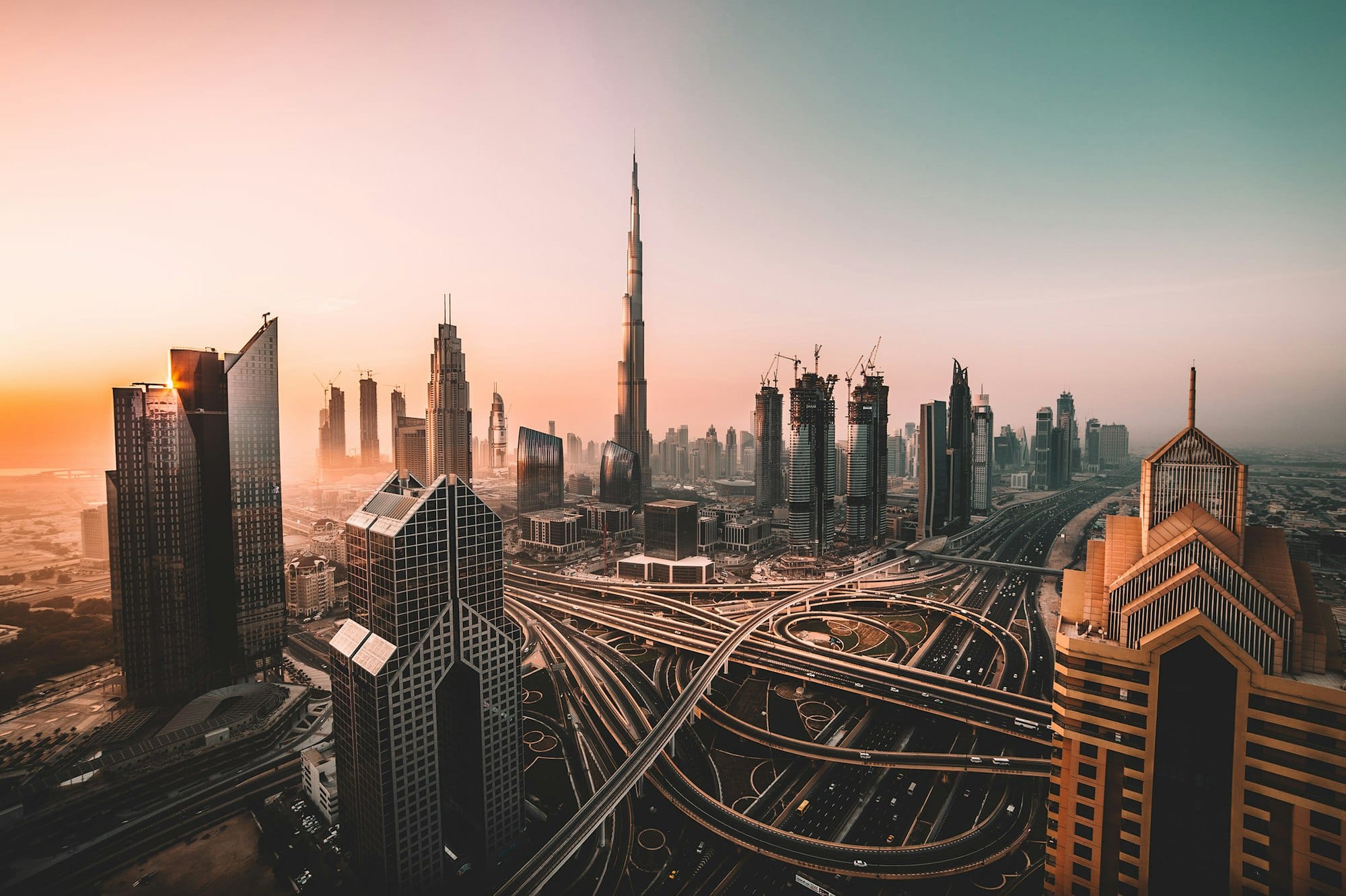 Dubai skyline with the Burj Khalifa and motorway junctions at golden hour